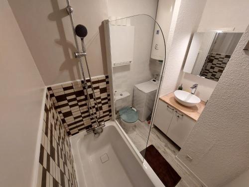 a bathroom with a shower and a tub and a sink at Le Studio du Queyras avec vue sur la montagne in Abriès