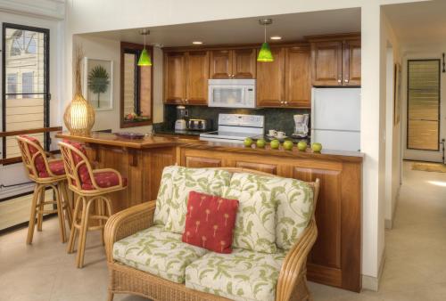 a living room with a couch and a kitchen at Gallows Point Resort in Saint John