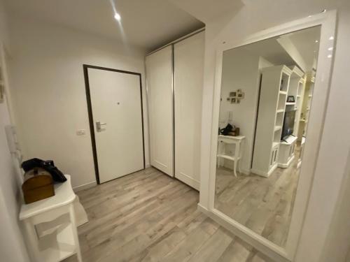 a white room with a mirror and a hallway at Durrës BelleVue 3 bdm Apartment in Durrës