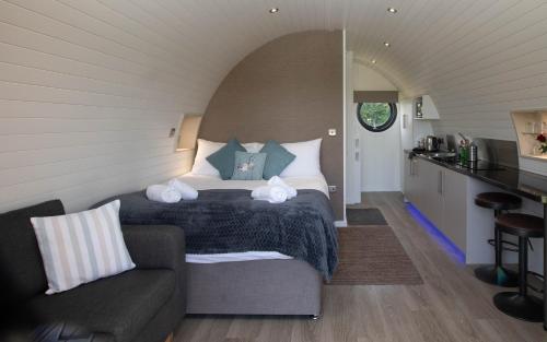 a bedroom with a bed and a couch in a room at Millview Meadow Retreats in Great Yarmouth