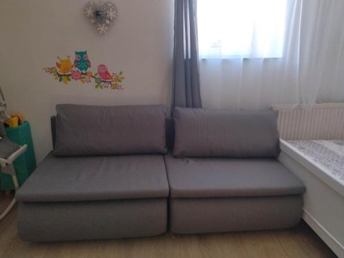 a couch sitting in a room with a window at Noclegi u Gosi in Jelenia Góra