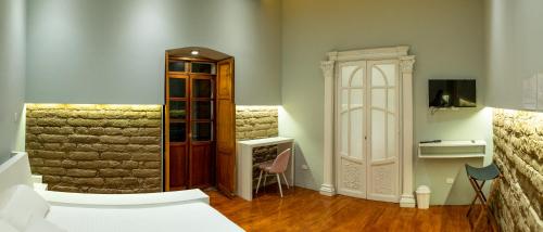 a room with a bed and a wooden cabinet at CASA ANABELA HOTEL BOUTIQUE in Quito