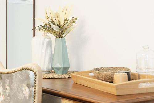 a table with a vase and a tray with flowers at Lugar do Ourives Boutique Hotel in Febres
