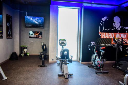 a gym with several exercise bikes in a room at Saraya Corniche Hotel in Doha