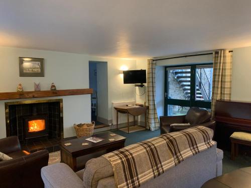 a living room with a couch and a fireplace at Ashley Croft in Skipton