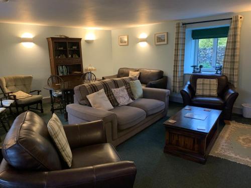 a living room with a couch and chairs and a table at Ashley Croft in Skipton