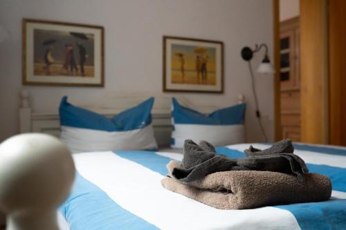 a bedroom with a bed with towels on it at Aparthotel Domizil in Borkum