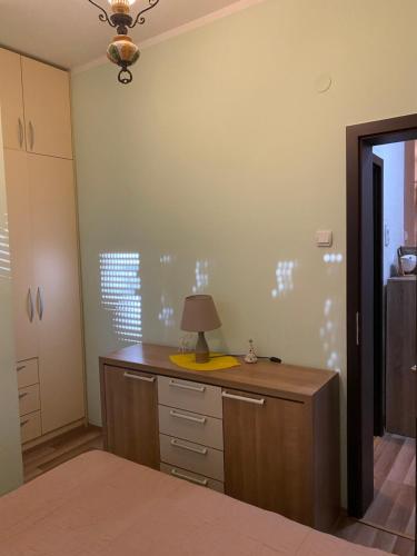 a room with a desk with a lamp on it at Apartment SIDRO Tivat in Tivat