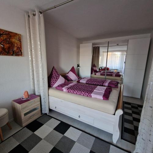 a bedroom with a bed with a large mirror at Ferienwohnung Berolina 116 in Dahme