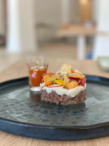 a plate with a piece of food on a table at Hotel Moresco in Santa Teresa Gallura