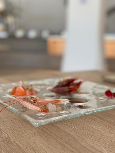 a plate of food sitting on a table at Hotel Moresco in Santa Teresa Gallura