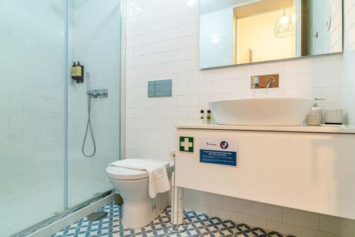 e bagno con lavandino, servizi igienici e doccia. di Republica I by Innkeeper a Porto