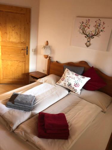 a large bed with pillows on top of it at Familienapartment Sonne und Schnee in Kanzelhöhe