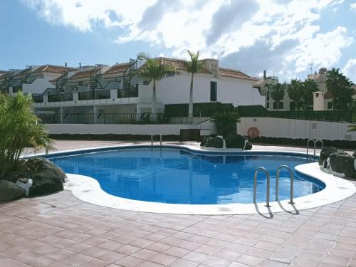 a large swimming pool in front of a house at El Mirador Los Cristianos in Los Cristianos