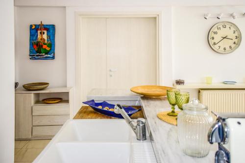 a kitchen with a sink and a clock on the wall at View Villas in Punta