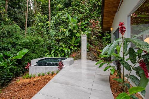 a walkway with a fountain in the middle of a garden at Vista Celestial in Uvita