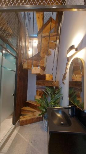 a bathroom with a sink and wooden stairs at ART - Balcescu in Sibiu