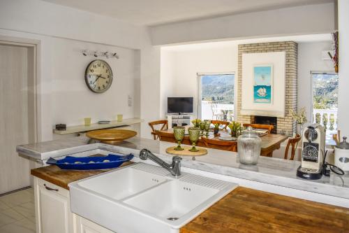 a kitchen with a sink and a living room at View Villas in Punta