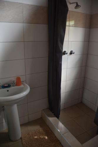 a bathroom with a sink and a shower at Tabonina Guesthouse in Livingstone
