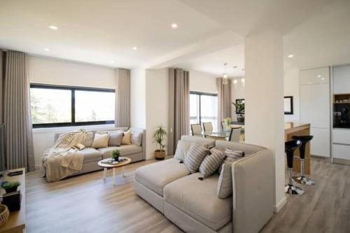 a living room with a couch and a table at Top View Apt at Historical Center in Coimbra