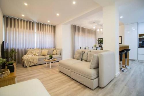 a living room with two couches and a table at Top View Apt at Historical Center in Coimbra