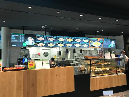 a fast food restaurant with a counter with pastries at Serways Hotel Spessart in Rohrbrunn