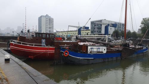 two boats docked next to each other in the water at Boat-Apartment Rotterdam Fokkelina in Rotterdam