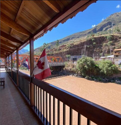 a view of a balcony with a canadian flag at Hospedaje Chaska Pisac in Pisac