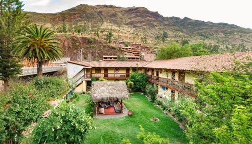 an aerial view of a house with a grass roof at Hospedaje Chaska Pisac in Pisac
