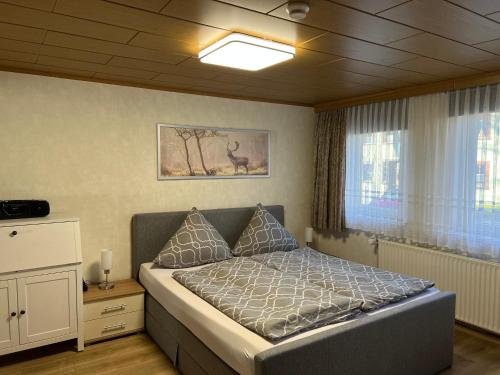 a bedroom with a bed and a window at Bergmannsruh in Clausthal-Zellerfeld
