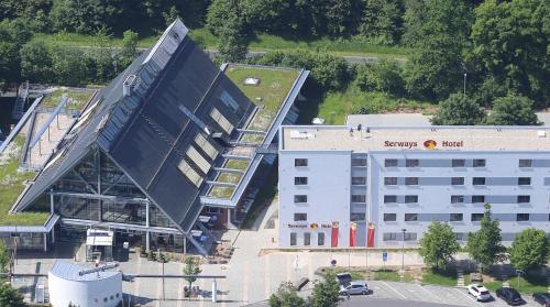 an overhead view of a large building next to a building at Serways Hotel Spessart in Rohrbrunn