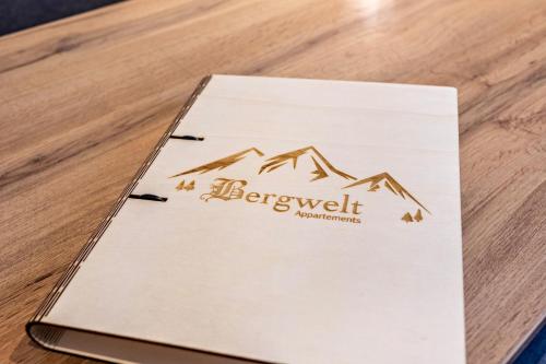 a book on a table with a mountain on it at Bergwelt B in Niederau