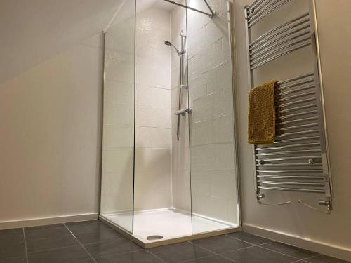 a shower with a glass door in a bathroom at Beautiful 4-Bed House in Lincoln- close to Centre in Lincoln