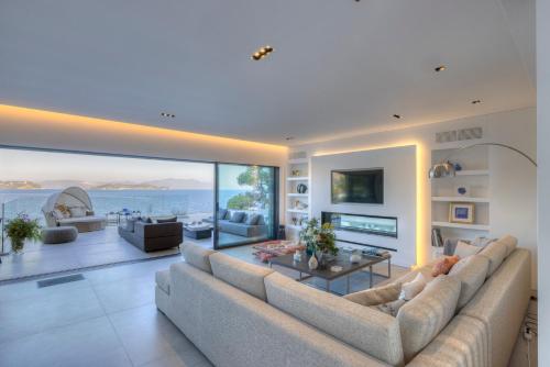 a living room with a large couch and a table at Luxury Villas Skiathos in Skiathos
