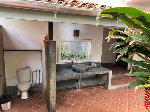 a bathroom with a sink and a toilet at Galawatta Beach Resort in Unawatuna