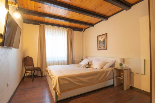 a bedroom with a bed in a room with a window at Club Satelit Zlatibor in Zlatibor