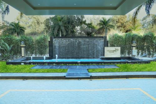 a swimming pool with a fountain in a yard at Triumph Plaza Hotel in Cairo