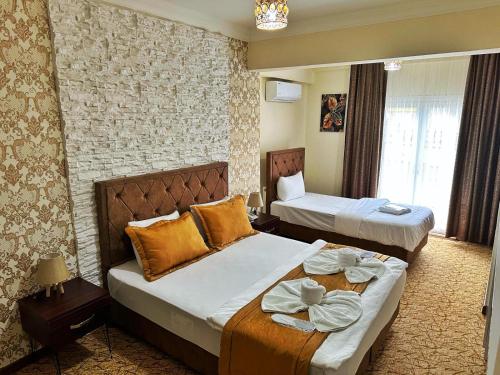 a hotel room with two beds in a room at Rose Suite & Hotel in Buyukcekmece