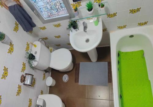 a bathroom with a sink and a toilet and a tub at Sea view 3-bedroom flat in Puerto de Mazarron in Puerto de Mazarrón