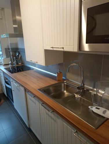 a kitchen with a sink and a microwave at Dúplex en Comillas in Comillas