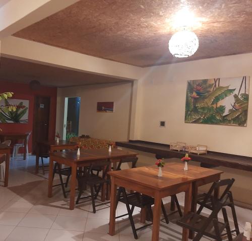 a dining room with wooden tables and chairs at Pousada Eucaliptos in Barra Grande