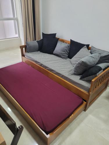 a wooden bed with a purple mattress at CALDAS NOVAS - RECANTO DO BOSQUE Flat Service AP209 in Caldas Novas