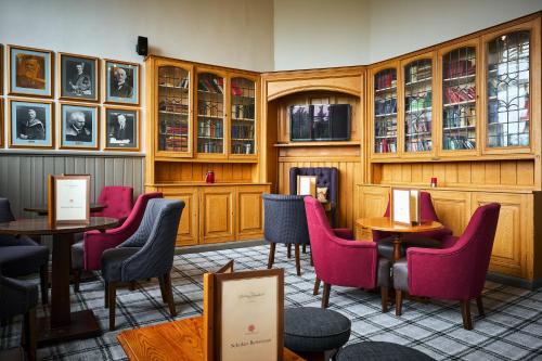 a restaurant with tables and chairs in a room at Stirling Highland Hotel- Part of the Cairn Collection in Stirling