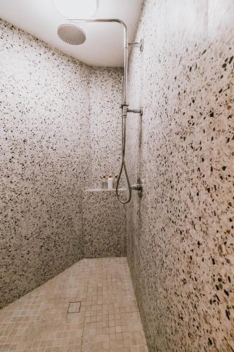 a bathroom with a shower with a tiled wall at Okt Häus in Nordegg