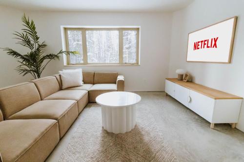 a living room with a couch and a table at Okt Häus in Nordegg