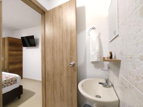 a bathroom with a sink and a toilet at Walena Hotel in Ríohacha