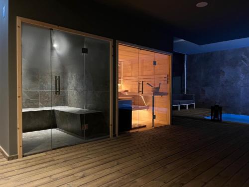 a bathroom with a shower and a tub at Pena D'Água Boutique Hotel & Villas in Covilhã