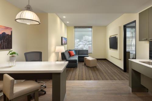 a living room with a couch and a table at Hyatt House Monterrey Valle San Pedro in Monterrey