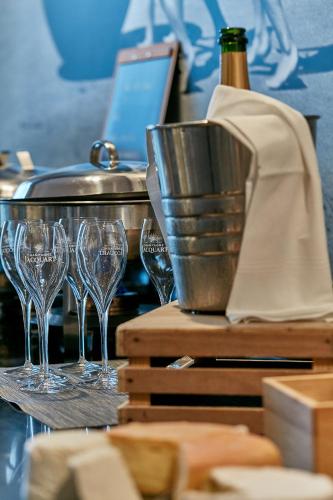 a group of wine glasses on a table with a bottle at Hôtel Château des Tourelles - Relais Thalasso & Spa in Pornichet