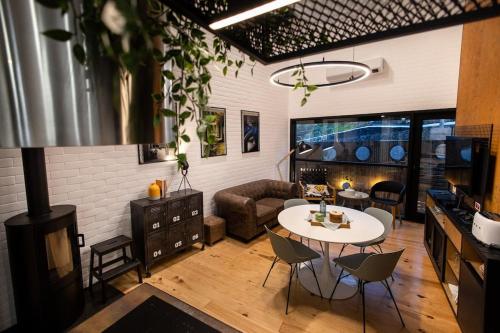 a living room with a table and a couch at Dark Studio in São Roque